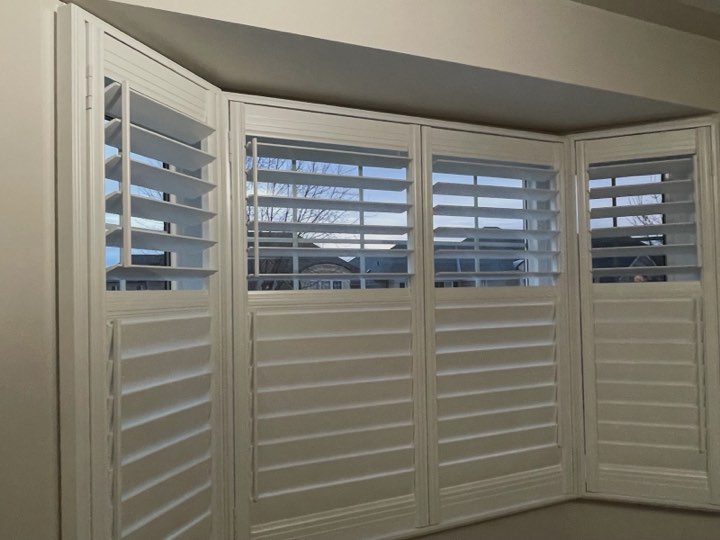 White wood shutters around a bay window