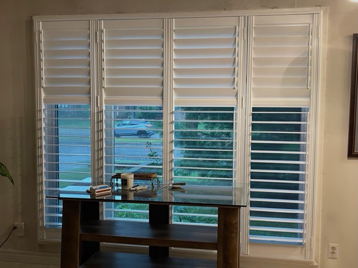 Four-panel wood shutters with the top louvres tilted open