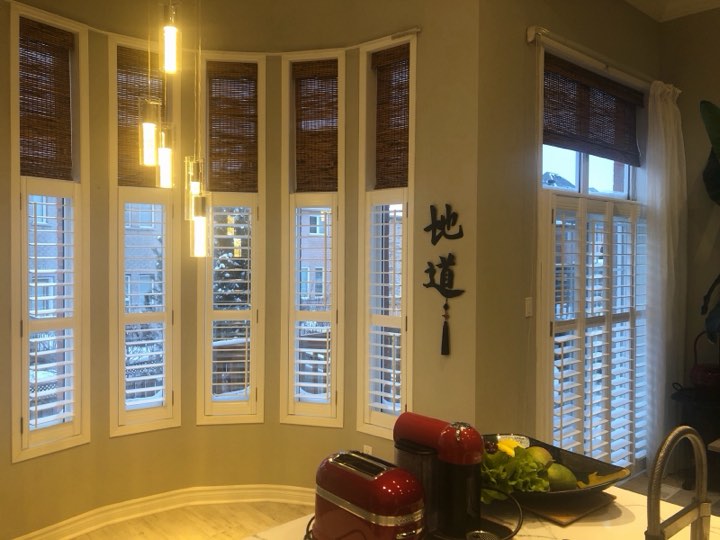 Shutters on a curved bay of kitchen windows