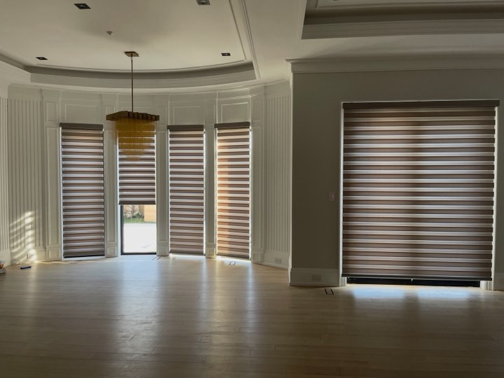 Zebra shades across a curved wall of windows
