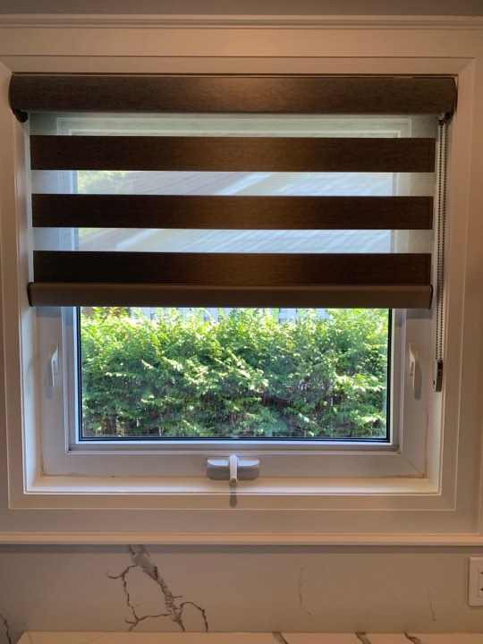 Brown zebra shade on a kitchen window