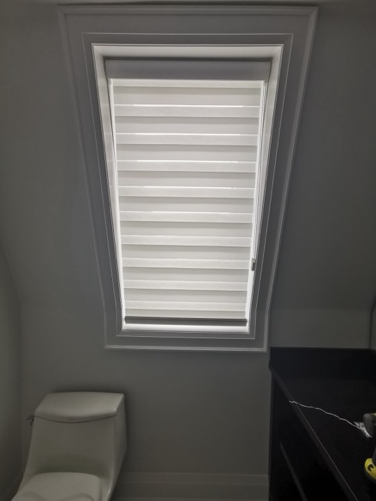 White zebra shade on an angled window