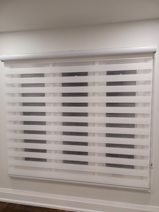 White zebra shade on a wide window